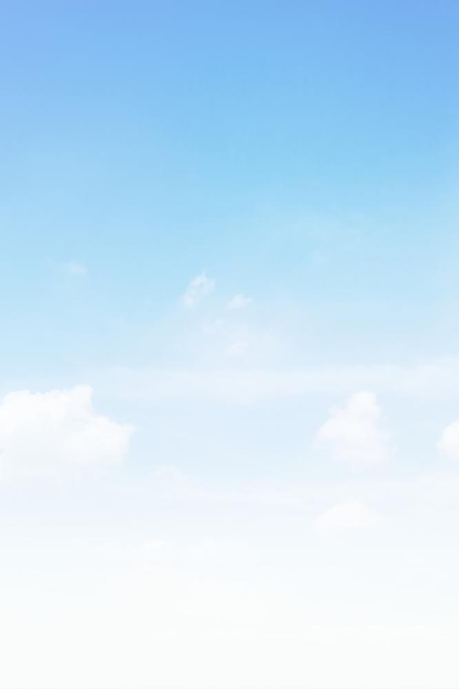 A serene, gradient blue sky is depicted with soft white clouds gently scattered across, creating a calming and peaceful atmosphere.